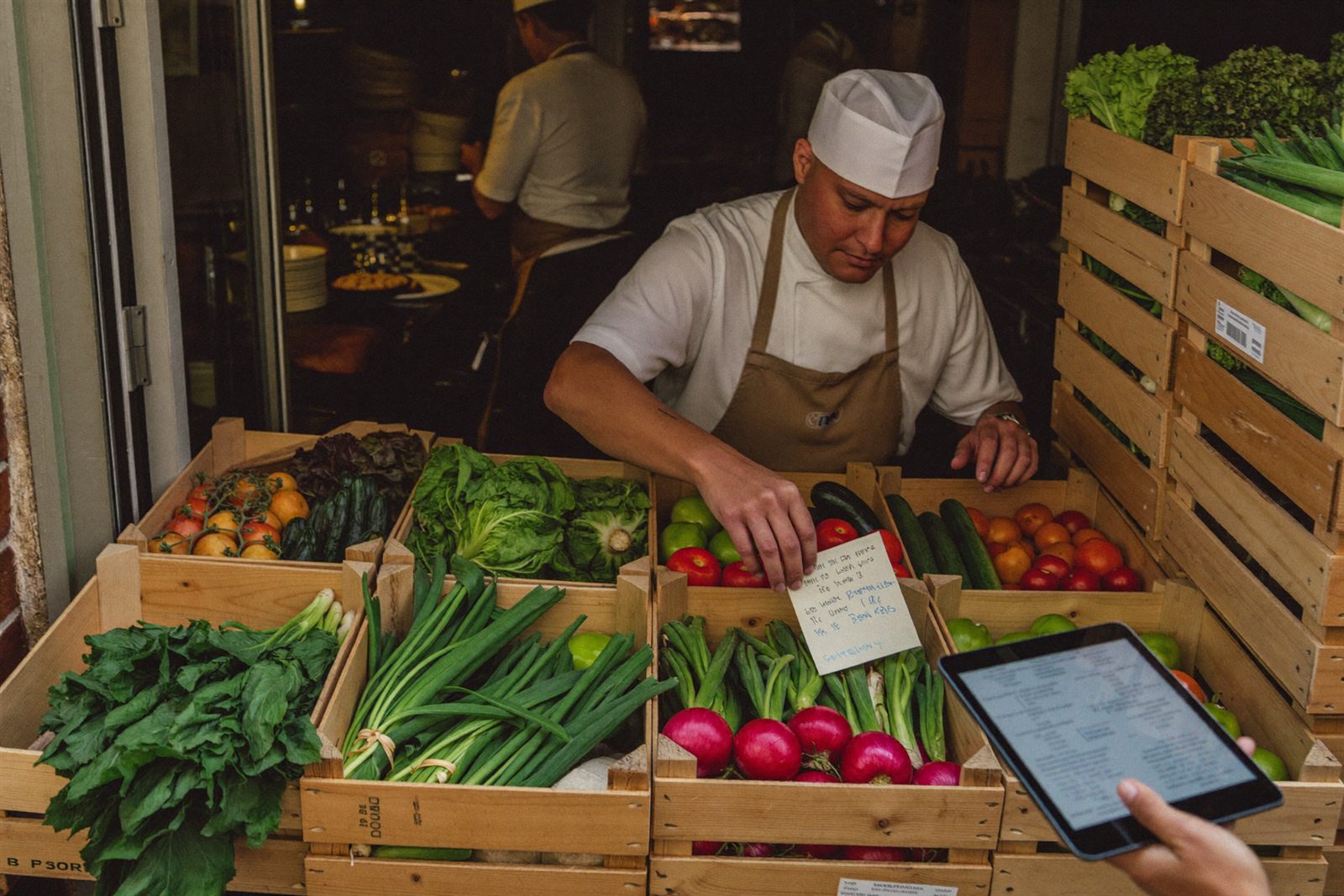 Chef receiving a produce delivery and checking the delivery note