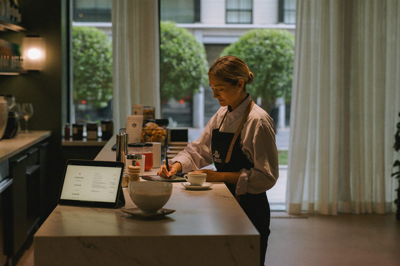 Restaurant owner reviewing Hospos on a tablet before opening